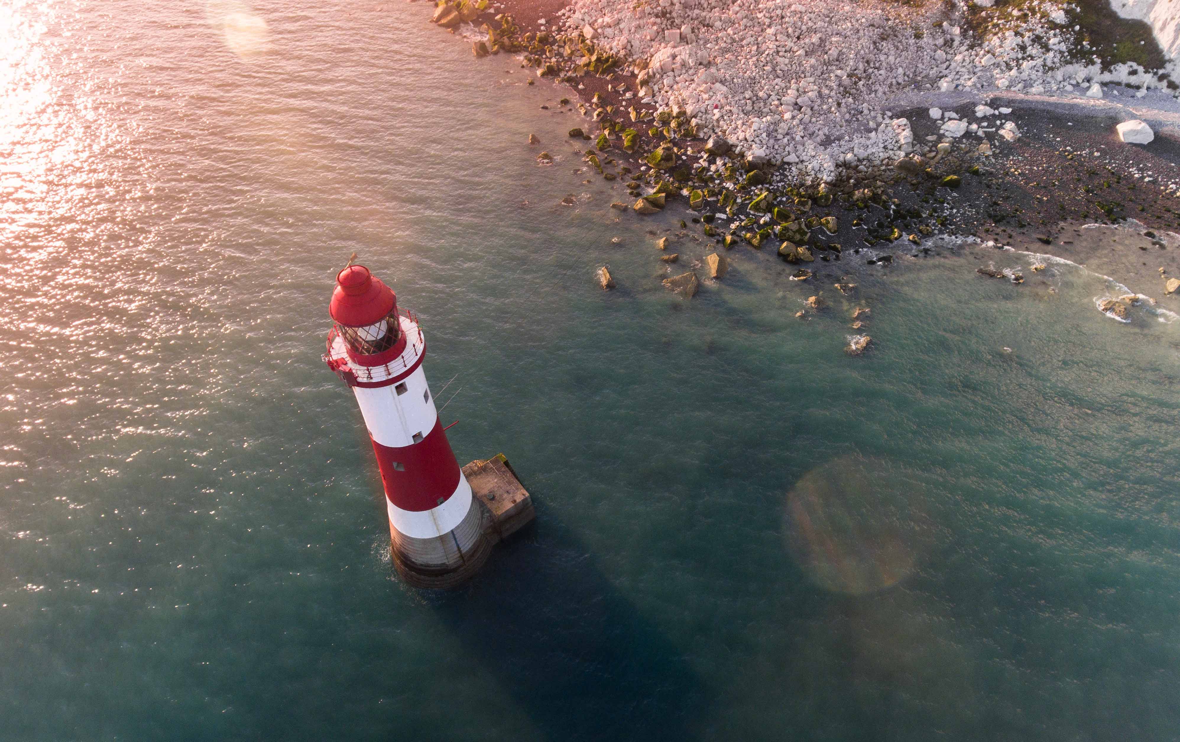 lighthouse and white cliffs photographed by drone